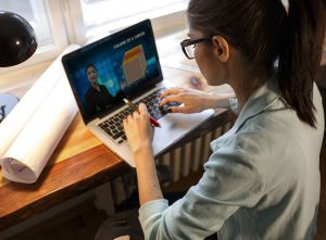 A Young Girl Sitting Infront Of The Laptop And Preparing For The COmpetitive Exam.